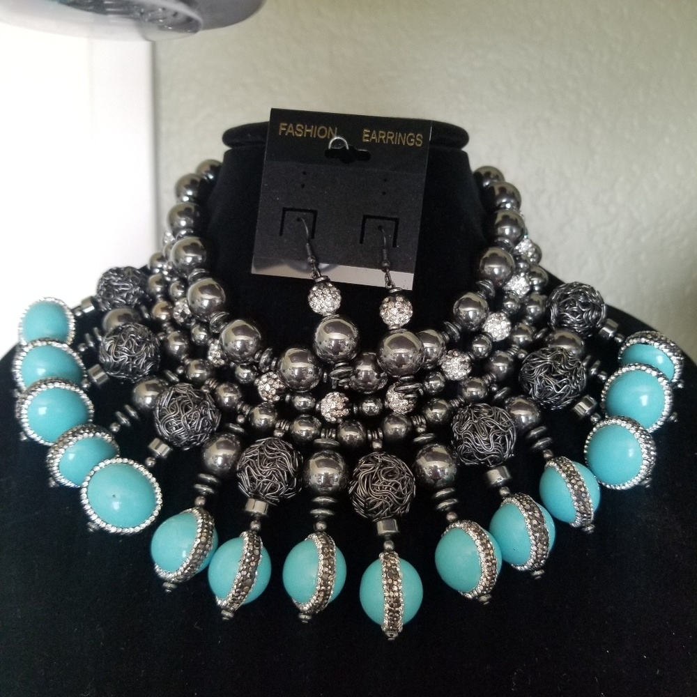 A statement necklace and earrings